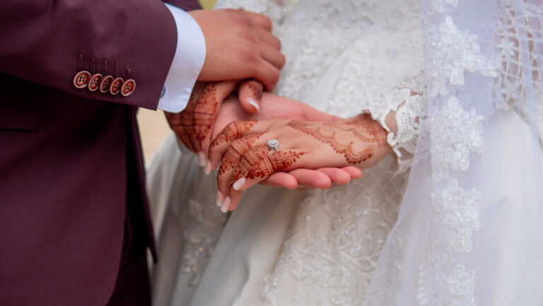 image de deux mariés se tenant la main